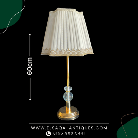 Golden lamp with Off white shade.